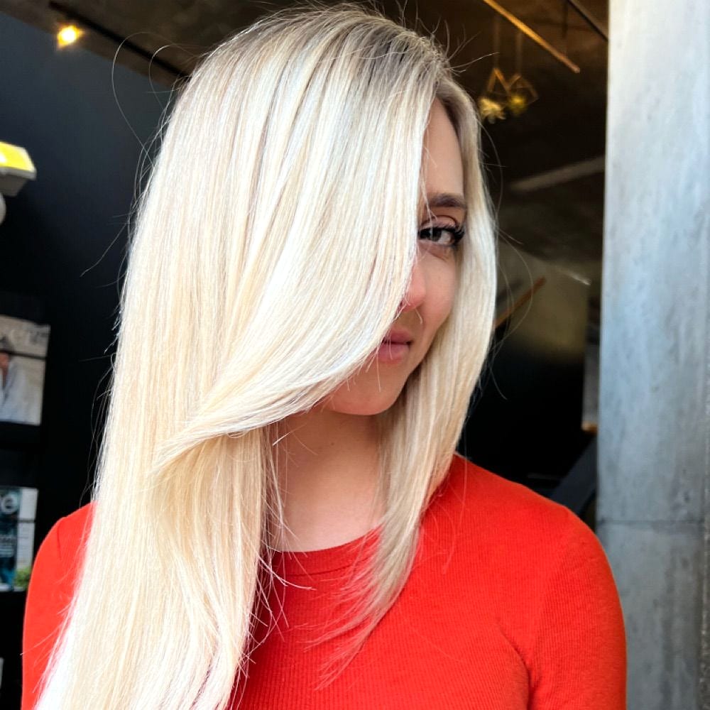 Sleek platinum blonde hair partly covering a client's face